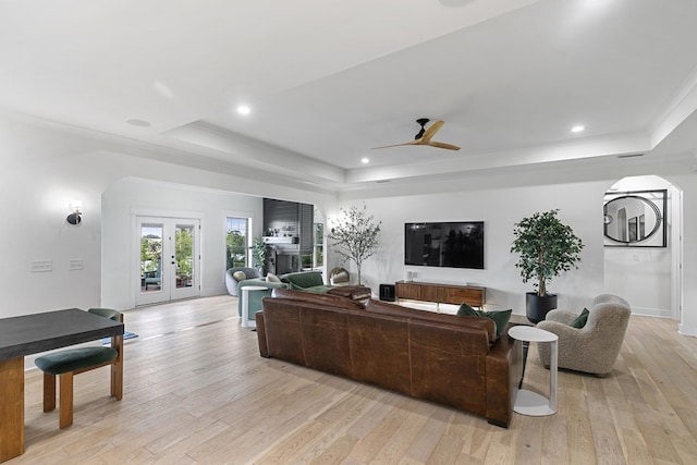 481 Grace Dr, Newton, AL 36352 - living area with a tray ceiling, arched walkways, light wood finished floors, a ceiling fan, and recessed lighting