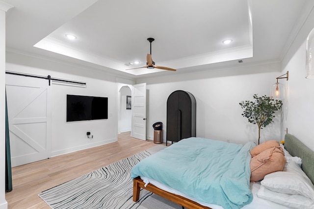 481 Grace Dr, Newton, AL 36352 - bedroom with a raised ceiling, ornamental molding, light wood-type flooring, arched walkways, and recessed lighting