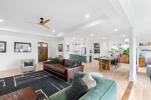 481 Grace Dr, Newton, AL 36352 - living area with arched walkways, a raised ceiling, a ceiling fan, light wood-style floors, and recessed lighting