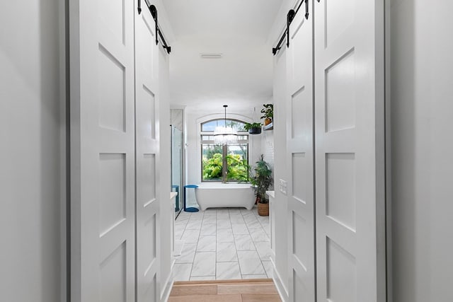 481 Grace Dr, Newton, AL 36352 - hall with a barn door and light marble finish flooring
