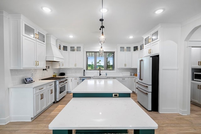 481 Grace Dr, Newton, AL 36352 - kitchen featuring premium appliances, custom range hood, a sink, light wood finished floors, and recessed lighting