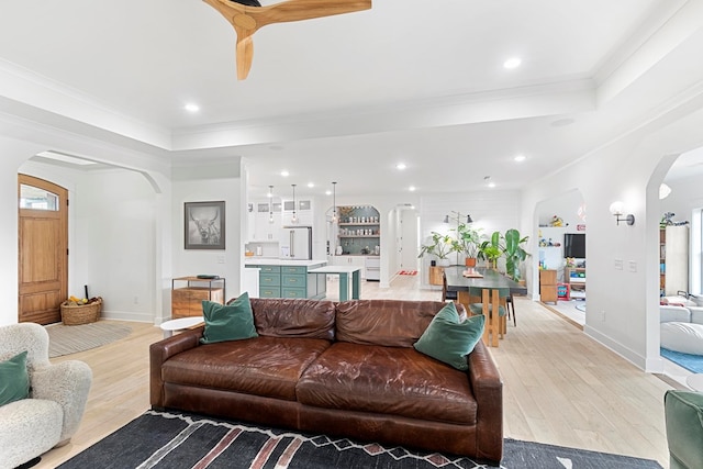 481 Grace Dr, Newton, AL 36352 - living room with arched walkways, light wood-style floors, baseboards, crown molding, and a raised ceiling