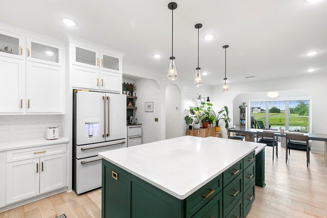 481 Grace Dr, Newton, AL 36352 - kitchen featuring green cabinetry, white fridge with ice dispenser, arched walkways, white cabinets, and light countertops