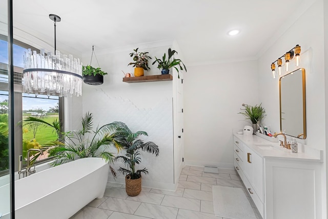 481 Grace Dr, Newton, AL 36352 - full bath featuring vanity, a soaking tub, a chandelier, crown molding, and marble finish flooring