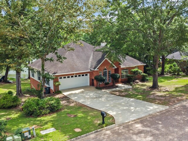 3602 Lake Oak Ridge Dr, Enterprise, AL 36330 - view of front of property with an attached garage, driveway, a shingled roof, and a front lawn