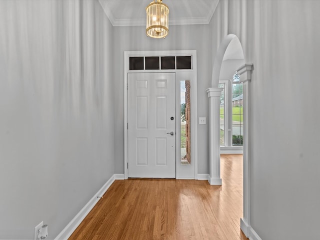 3602 Lake Oak Ridge Dr, Enterprise, AL 36330 - entryway featuring baseboards, wood finished floors, a chandelier, ornamental molding, and arched walkways
