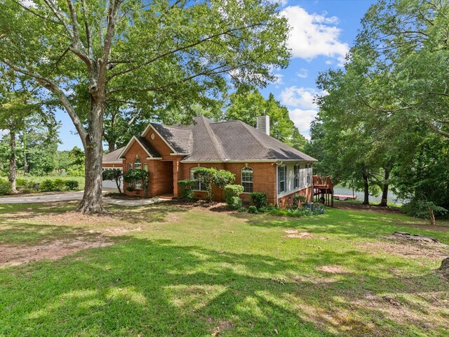 3602 Lake Oak Ridge Dr, Enterprise, AL 36330 - view of front facade featuring a chimney, brick siding, and a front lawn