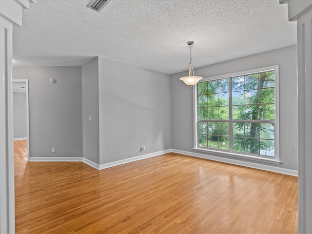 3602 Lake Oak Ridge Dr, Enterprise, AL 36330 - spare room featuring baseboards, light wood-style floors, and a textured ceiling