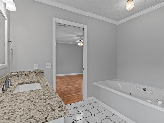 3602 Lake Oak Ridge Dr, Enterprise, AL 36330 - bathroom featuring a textured ceiling, a jetted tub, vanity, ceiling fan, and tile patterned floors