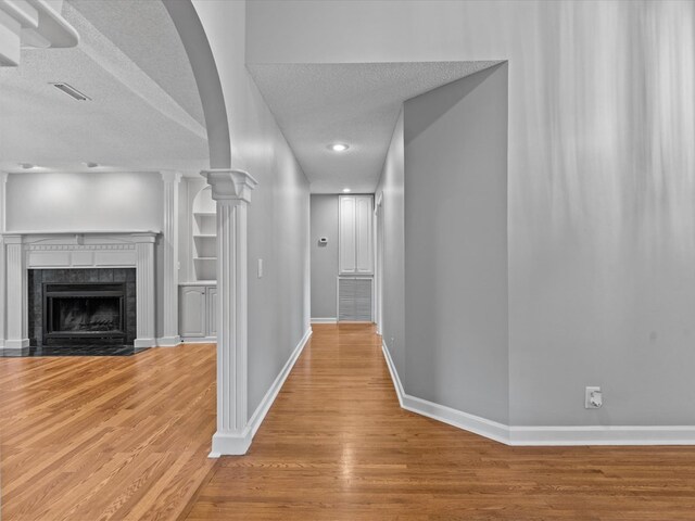 3602 Lake Oak Ridge Dr, Enterprise, AL 36330 - hall featuring a textured ceiling, light wood finished floors, baseboards, decorative columns, and recessed lighting