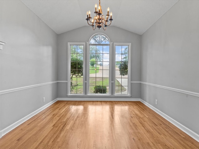 3602 Lake Oak Ridge Dr, Enterprise, AL 36330 - unfurnished room featuring a chandelier, light wood-style flooring, vaulted ceiling, and baseboards