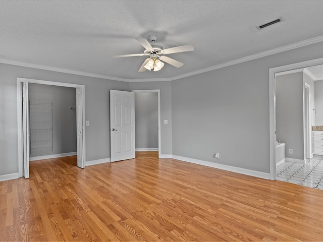 3602 Lake Oak Ridge Dr, Enterprise, AL 36330 - unfurnished bedroom with light wood-type flooring, a textured ceiling, ornamental molding, ensuite bathroom, and baseboards