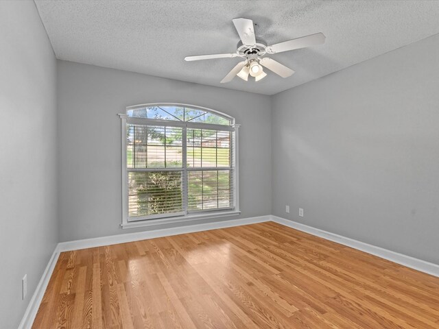 3602 Lake Oak Ridge Dr, Enterprise, AL 36330 - unfurnished room with light wood-type flooring, a textured ceiling, baseboards, and a ceiling fan