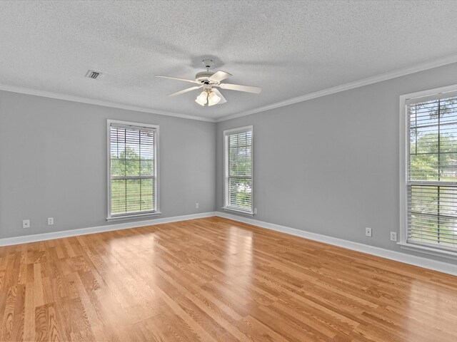 3602 Lake Oak Ridge Dr, Enterprise, AL 36330 - spare room featuring healthy amount of natural light, light wood finished floors, ornamental molding, ceiling fan, and a textured ceiling