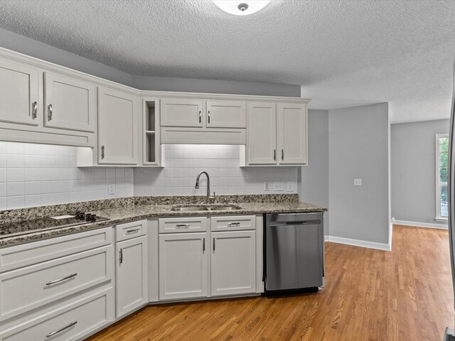 3602 Lake Oak Ridge Dr, Enterprise, AL 36330 - kitchen with stainless steel dishwasher, a sink, black electric cooktop, white cabinets, and light wood-type flooring