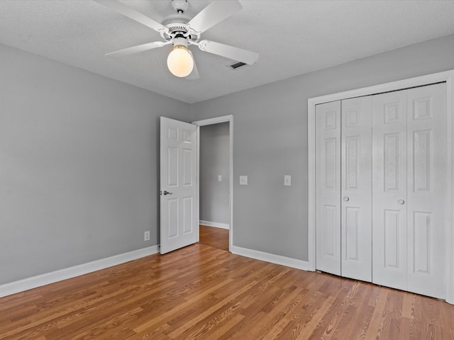 3602 Lake Oak Ridge Dr, Enterprise, AL 36330 - unfurnished bedroom featuring light wood finished floors, baseboards, a closet, and a ceiling fan