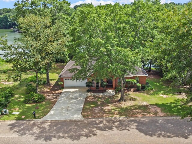 3602 Lake Oak Ridge Dr, Enterprise, AL 36330 - view of property hidden behind natural elements with an attached garage, concrete driveway, and a front lawn