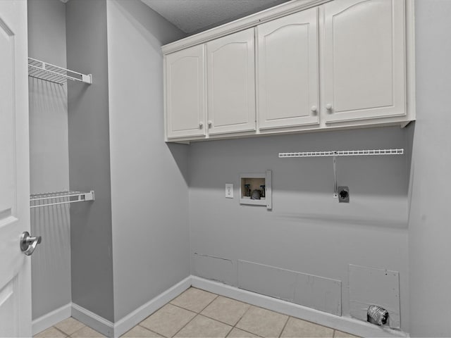 3602 Lake Oak Ridge Dr, Enterprise, AL 36330 - washroom with hookup for an electric dryer, washer hookup, light tile patterned floors, cabinet space, and baseboards
