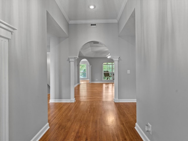 3602 Lake Oak Ridge Dr, Enterprise, AL 36330 - hall featuring ornate columns, arched walkways, wood finished floors, baseboards, and crown molding