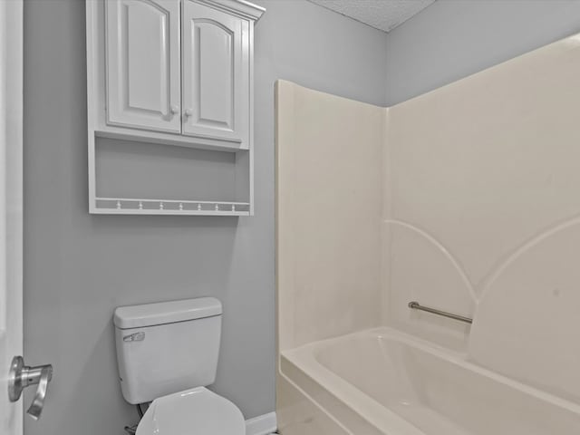 3602 Lake Oak Ridge Dr, Enterprise, AL 36330 - bathroom with toilet, baseboards, shower / bathtub combination, and a textured ceiling