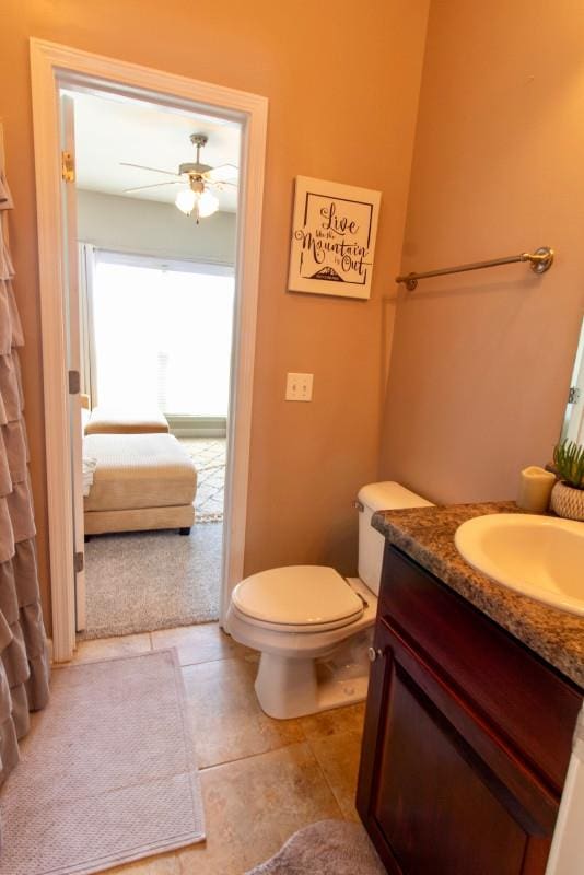 bathroom with vanity, a ceiling fan, tile patterned flooring, and toilet