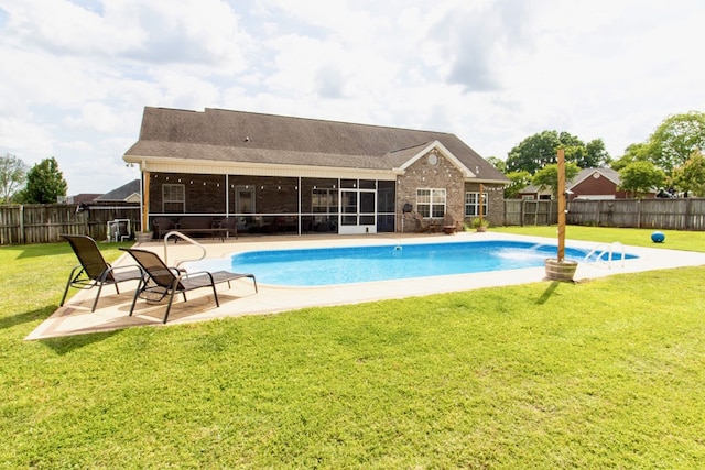 view of swimming pool with a fenced backyard, a fenced in pool, a sunroom, and a patio area