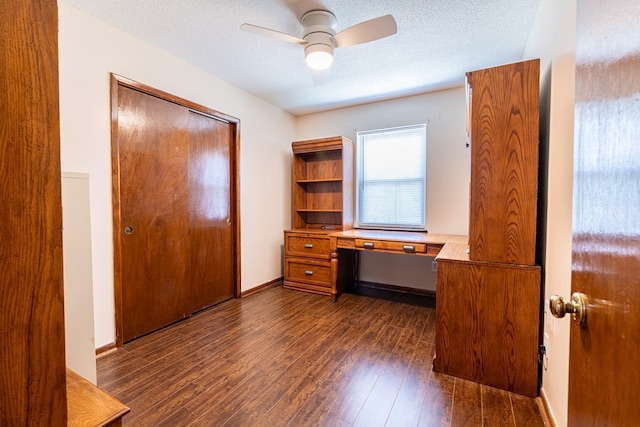 847 Phyllis Ave, Enterprise, AL 36330 - unfurnished office featuring built in desk, dark wood-style floors, a ceiling fan, and a textured ceiling