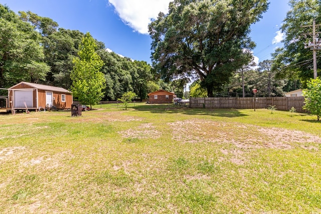 847 Phyllis Ave, Enterprise, AL 36330 - view of yard featuring an outbuilding, a garage, and view of wooded area