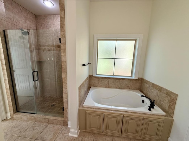 bathroom featuring tile patterned flooring and independent shower and bath