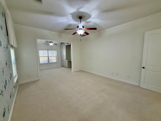 spare room featuring crown molding and light carpet