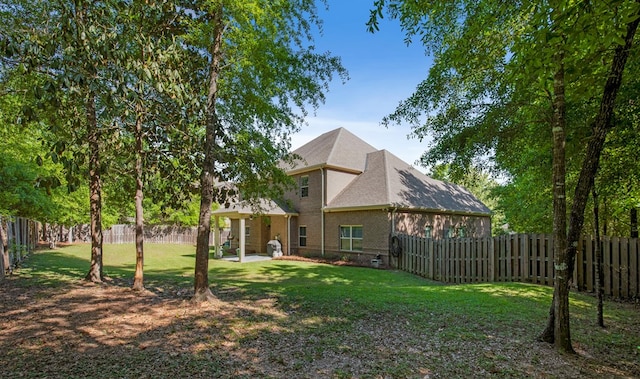 rear view of house featuring a yard