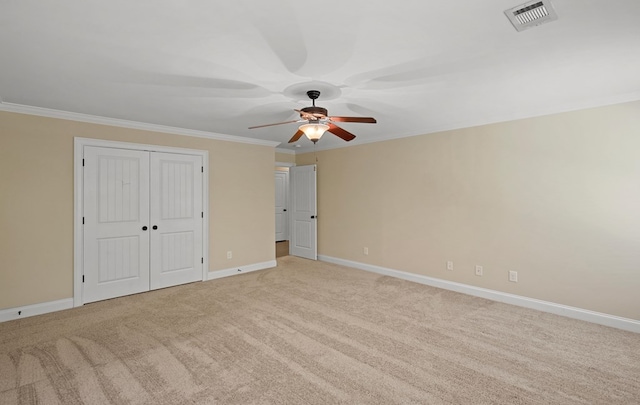 unfurnished bedroom with crown molding, light carpet, and ceiling fan