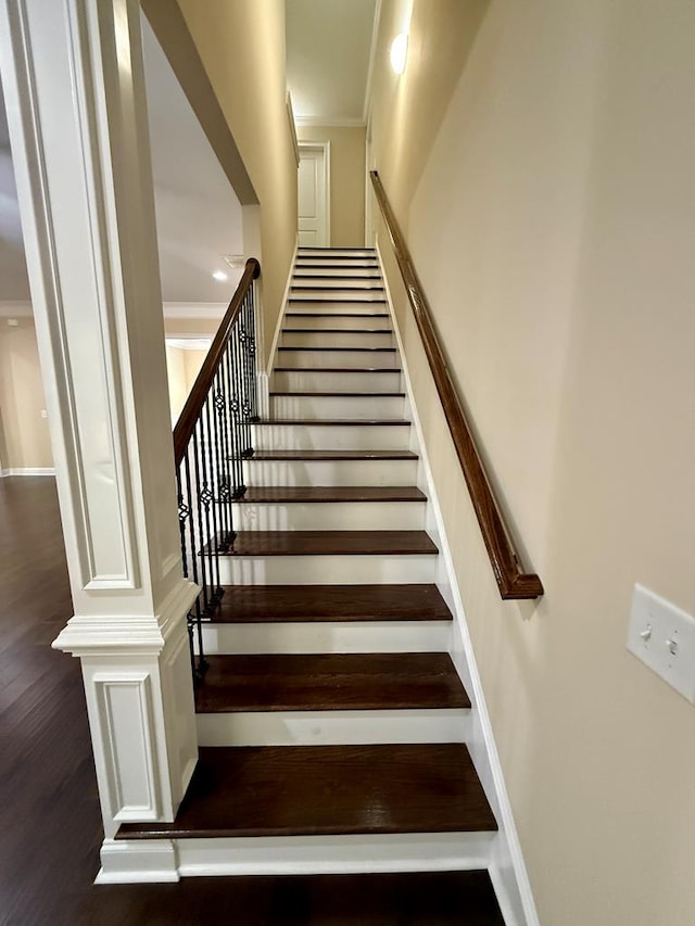 staircase featuring crown molding