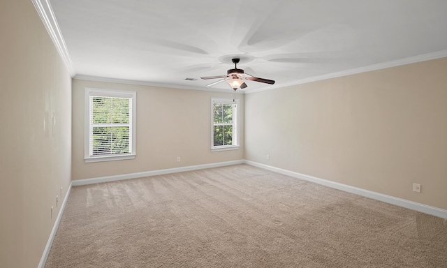 carpeted spare room featuring ornamental molding and ceiling fan