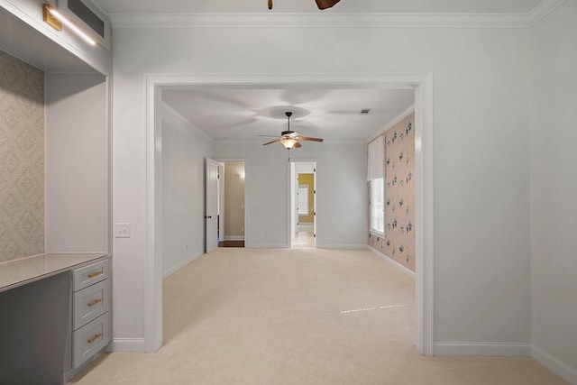 carpeted spare room featuring ornamental molding and ceiling fan