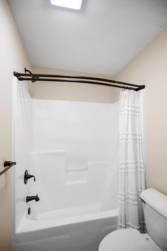 bathroom with shower / bath combo and toilet