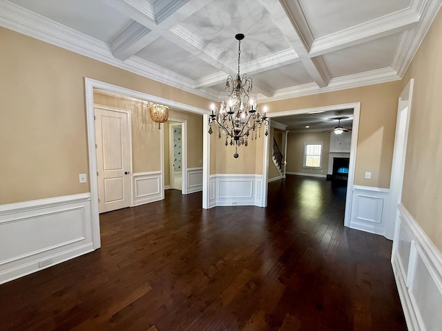 unfurnished dining area with coffered ceiling, beam ceiling, and ornamental molding