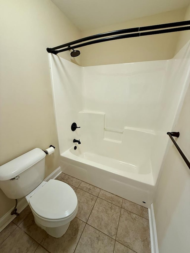 bathroom featuring shower / washtub combination, toilet, and tile patterned flooring