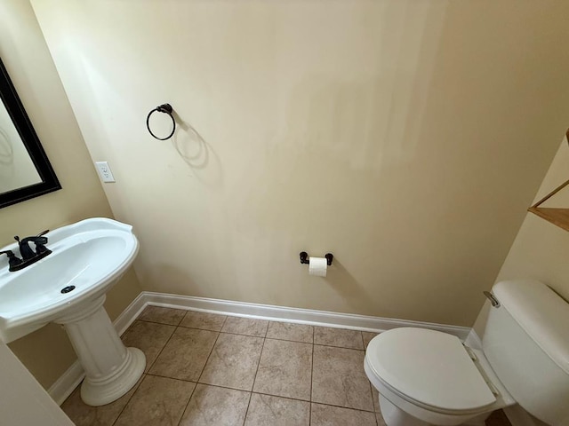 bathroom featuring tile patterned floors and toilet