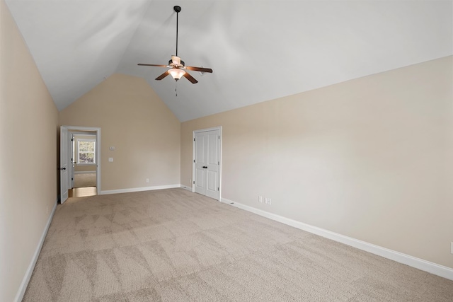 carpeted spare room with lofted ceiling and ceiling fan