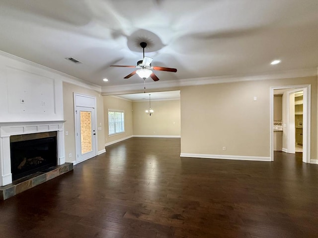 unfurnished living room featuring dark wood-type flooring, a fireplace, ornamental molding, and ceiling fan with notable chandelier