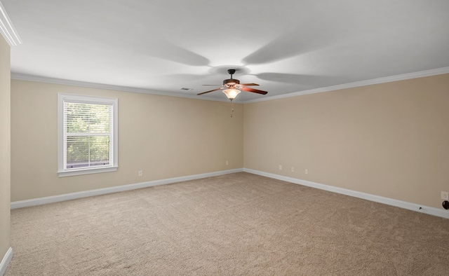 carpeted empty room featuring crown molding and ceiling fan