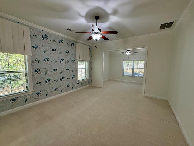 unfurnished room with ornamental molding and light carpet