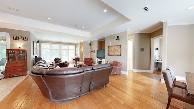 living area with baseboards, ornamental molding, light wood-style floors, and recessed lighting