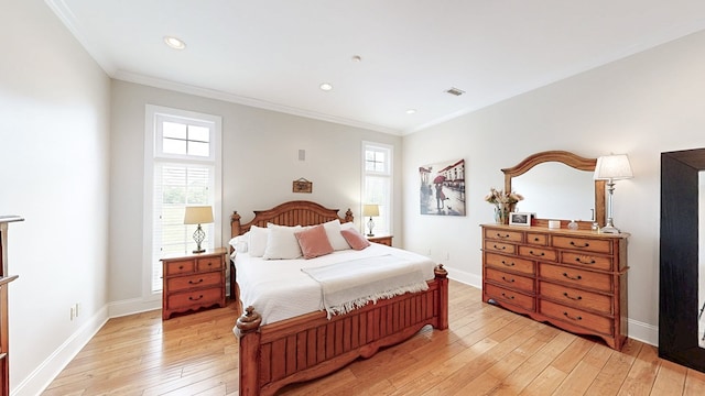 bedroom featuring light wood-style floors, crown molding, and multiple windows