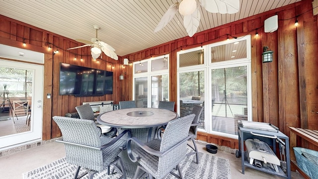 sunroom featuring outdoor dining space and ceiling fan