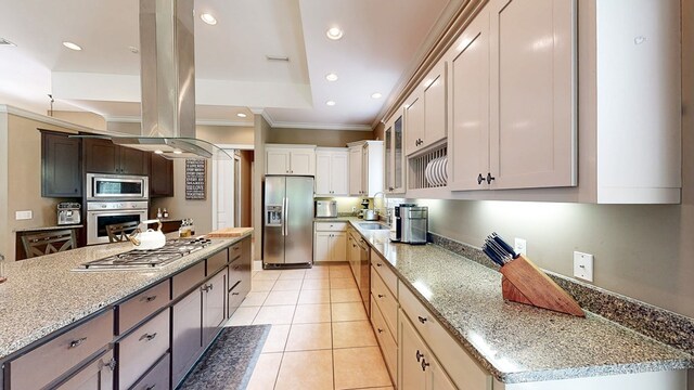 kitchen featuring light stone counters, stainless steel appliances, ornamental molding, light tile patterned floors, and glass insert cabinets