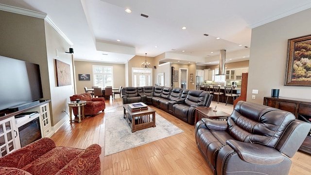 living room featuring visible vents, recessed lighting, a notable chandelier, light wood-style floors, and ornamental molding
