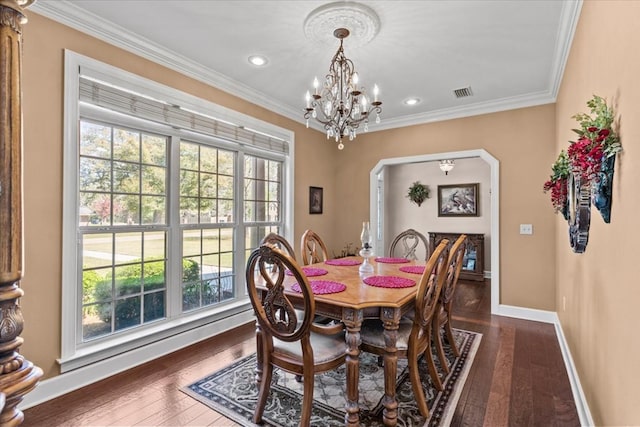 dining area featuring visible vents, crown molding, baseboards, dark wood-type flooring, and an inviting chandelier