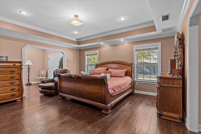 bedroom featuring dark wood-type flooring, baseboards, visible vents, and a raised ceiling